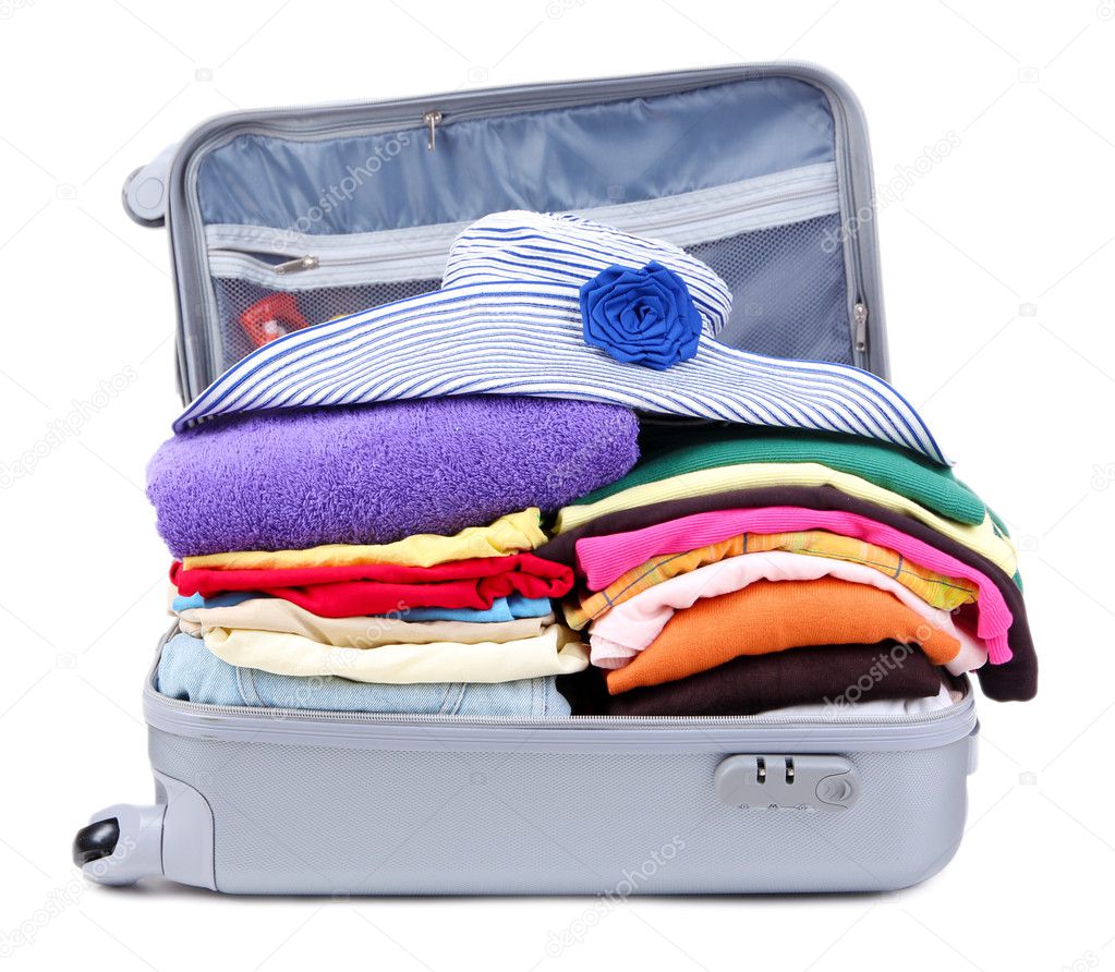 Open silver suitcase with clothing isolated on white