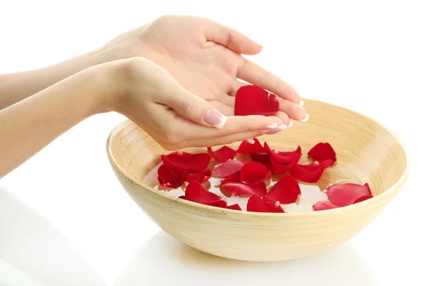 Woman hands with wooden bowl of water with petals, isolated on white — Stock Photo, Image