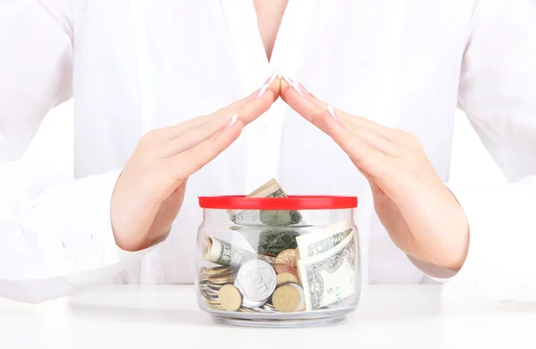 Woman hands with money in glass jar, close up — Stock Photo, Image