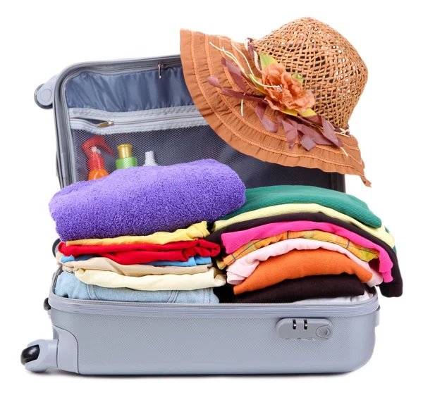 Open silver suitcase with clothing isolated on white — Stock Photo, Image