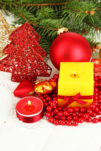 Yellow candle with christmas decoration on light background — 图库照片