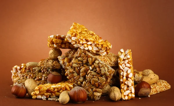 Tasty sweets (kozinaki), on brown background — Stock Photo, Image