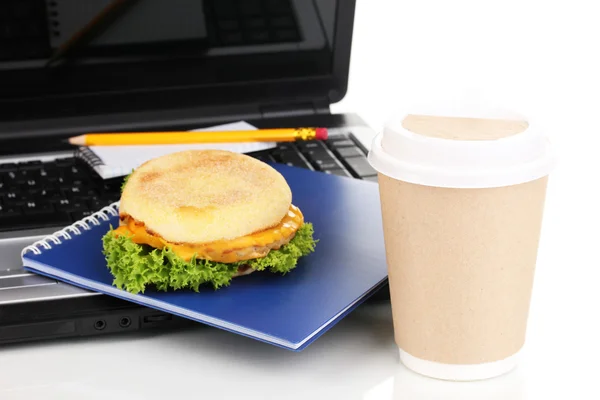 Eating at work place near laptop — Stock Photo, Image