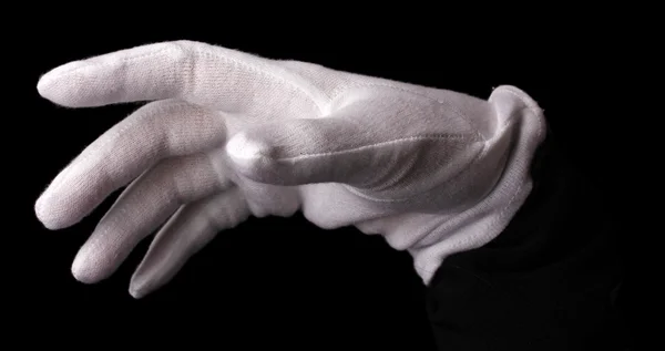 Mano en guante blanco haciendo cartel aislado en negro — Foto de Stock