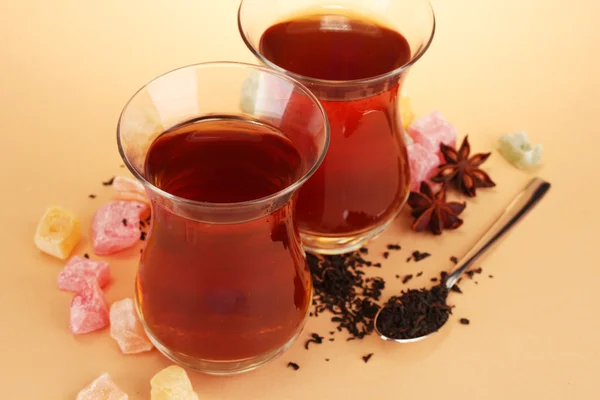 Glasses of Turkish tea and rahat Delight, on beige background — Stock Photo, Image