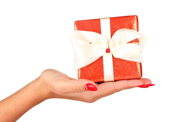 Woman holds box with gift on white background close-up — Stock fotografie