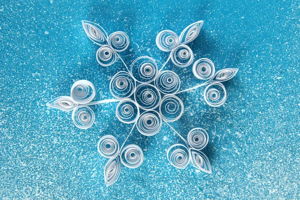 Beautiful paper snowflake, on blue background — Stock Photo, Image