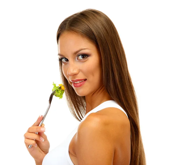 Hermosa joven con ensalada en tenedor, aislado en blanco — Foto de Stock