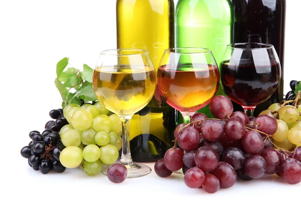 Bottles and glasses of wine and assortment of grapes, isolated on white Royalty Free Stock Photos