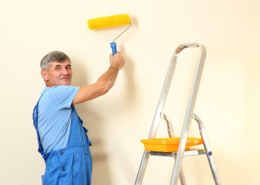Oda yakın erkek ressam boyalar duvar