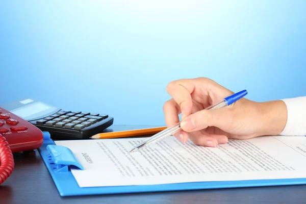 Signing of a treaty, on blue background close-up — Stock Photo, Image