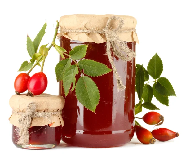 Jars with hip roses jam and ripe berries, isolated on white — Stock Photo, Image