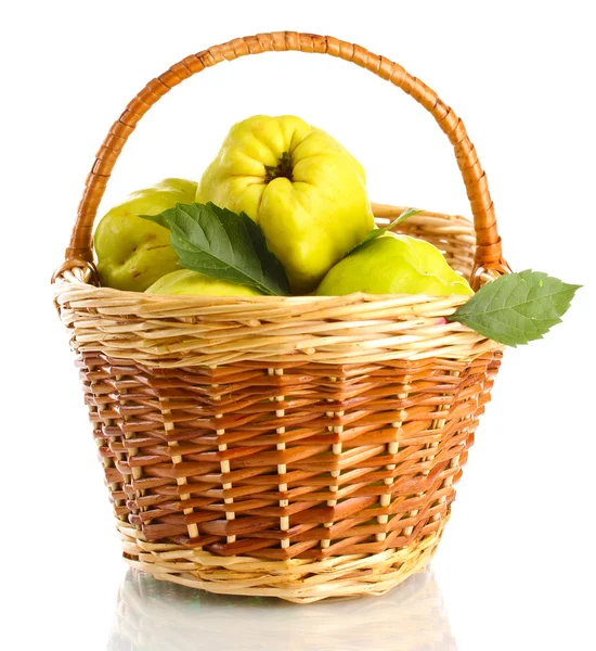 Sweet quinces with leaves in basket, isolated on white — Stock Photo, Image