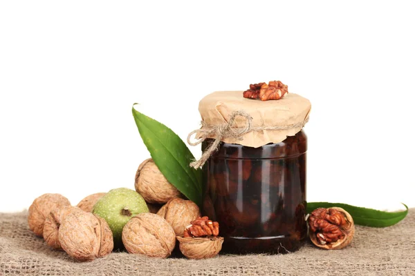Jam-jar of walnuts on sacking — Stock Photo, Image