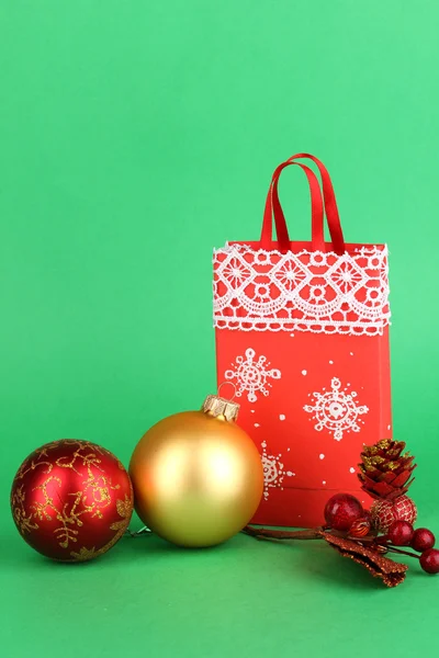 Christmas paper bag for gifts on green background — Stock Photo, Image