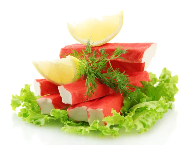 Crab sticks on lettuce leaves with lemon, isolated on white — Stock Photo, Image