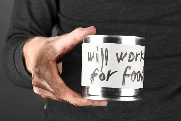 Homeless man asks for help, on black background close-up — Stock Photo, Image