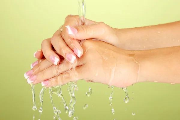 Lavar as mãos da mulher no fundo verde close-up — Fotografia de Stock