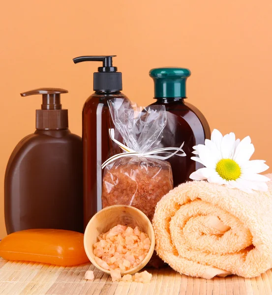 Set for care of a body on peach background — Stock Photo, Image