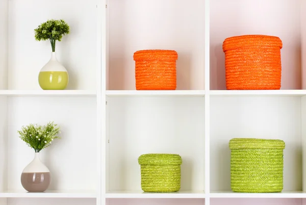 Color wicker boxes on cabinet shelves — Stock Photo, Image