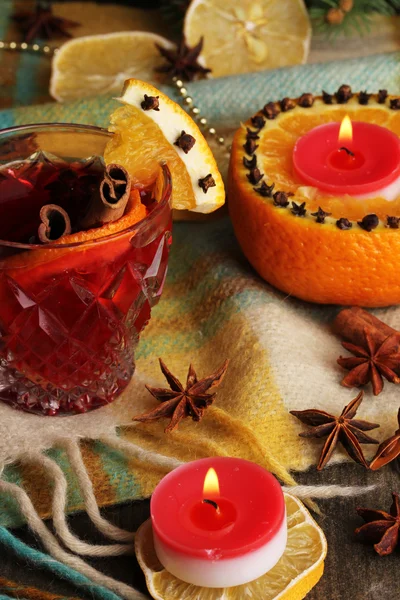 Vino caliente fragante en vaso con especias y naranjas en la mesa de madera —  Fotos de Stock