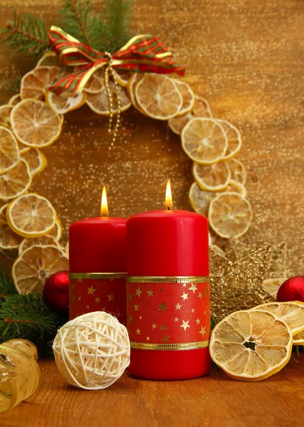 Two candles and christmas decorations, on golden background — Stock Photo, Image