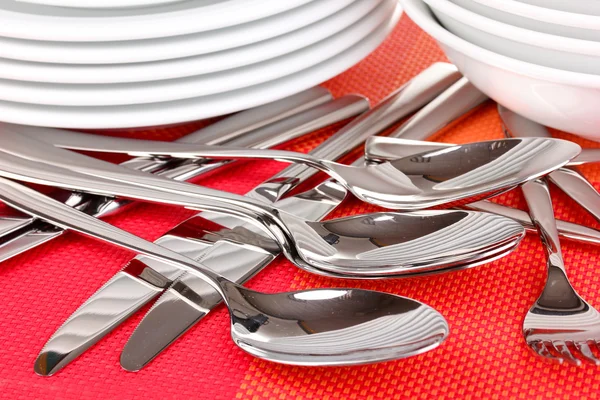 Forks, knifes and spoons on red mat close-up — Stock Photo, Image