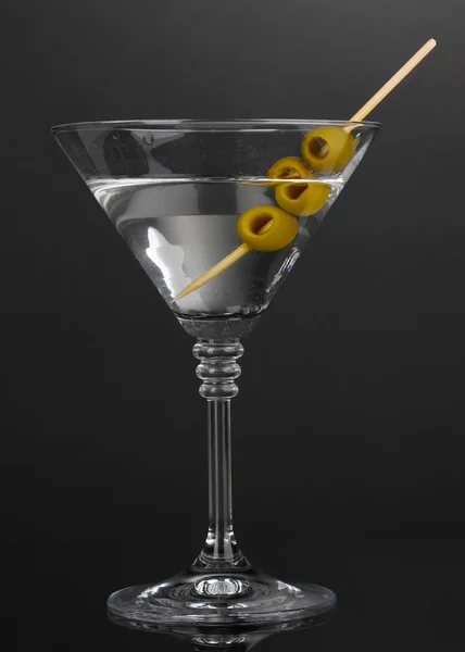 Martini glass and olives on grey background — Stock Photo, Image
