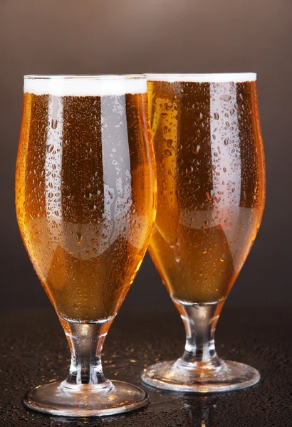 Glasses of beer on brown background — Stock Photo, Image