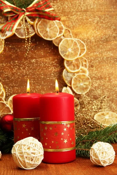 Two candles and christmas decorations, on golden background — Stock Photo, Image