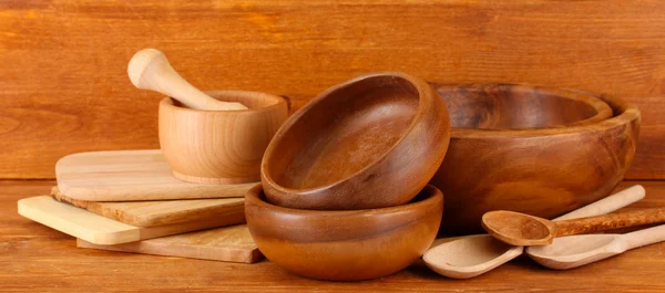 Wooden kitchen utensils on wooden background — Stock Photo, Image