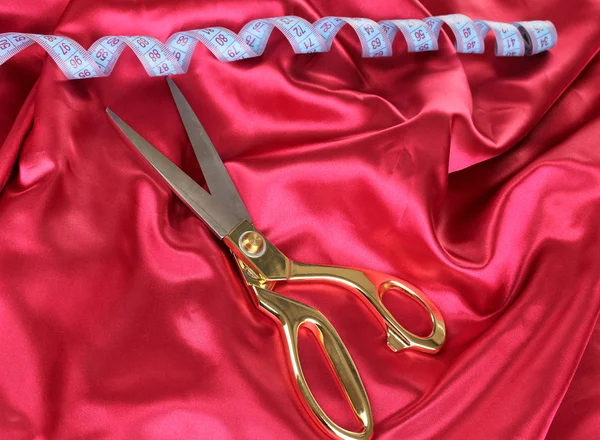 Metal scissors on red fabric — Stock Photo, Image