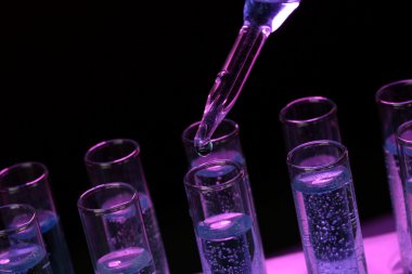 siyah arka plan üzerine sıvı ile test tüpleri