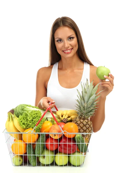 Mooie jonge vrouw met groenten en fruit in het winkelmandje, geïsoleerd op wit — Stockfoto