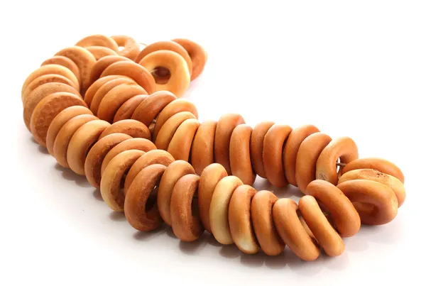 Smakelijke bagels op touw, geïsoleerd op wit — Stockfoto
