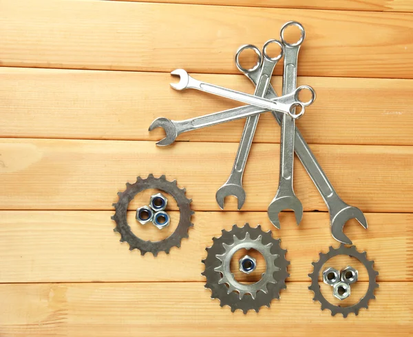 Machine gear, metal cogwheels, nuts and bolts on wooden background — Stock Photo, Image