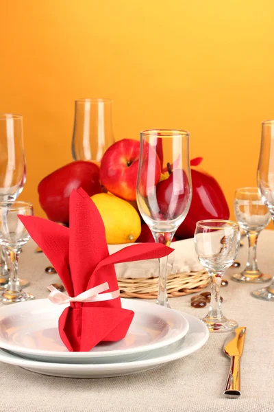 Настройка стола в красных тонах на цветном фоне — стоковое фото