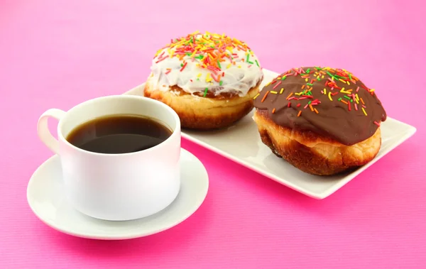 Tasty donuts on color plate on color background — Stock Photo, Image
