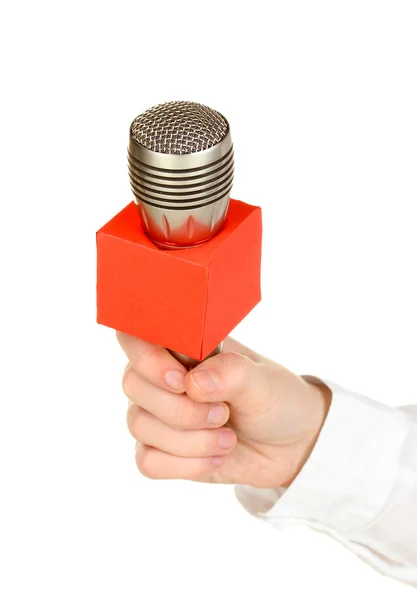 Mano femminile con microfono isolato su bianco — Foto Stock