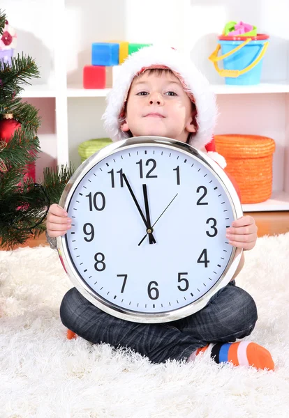 Little boy with clock in anticipation of New Year Stock Image