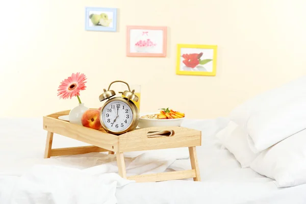 Wooden tray with light breakfast on bed — Stock Photo, Image