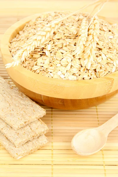 Wooden bowl full of oat flakes — Stock Photo, Image