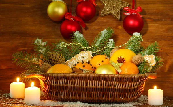 Χριστουγεννιάτικη σύνθεση σε καλάθι με πορτοκάλια και ελάτης, σε φόντο ξύλινη — 图库照片