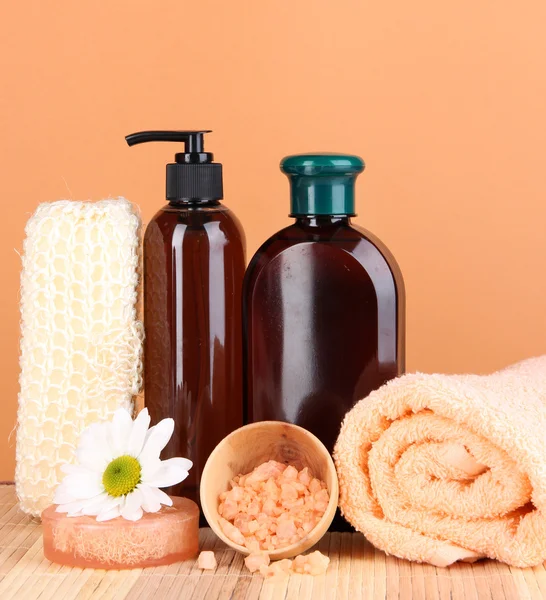 Set for care of a body on peach background — Stock Photo, Image