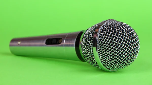 Silver microphone on green background — Stock Photo, Image