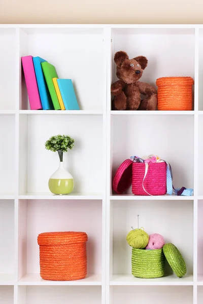 Color wicker boxes on cabinet shelves — Stock Photo, Image