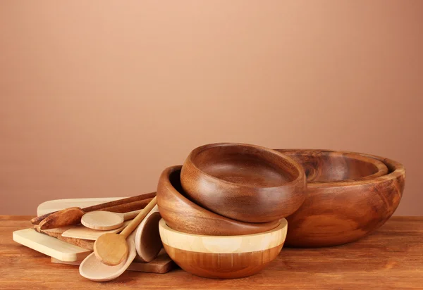 Wooden kitchen utensils on table on brown background — Stock Photo, Image