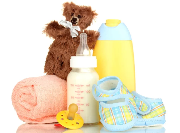 Bottle of milk, pacifier and baby cosmetic with towel isolated on white — Stock Photo, Image