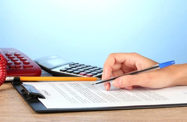 Signing of a treaty, on blue background close-up — Stock Photo, Image