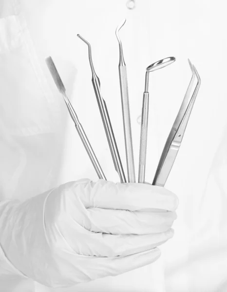 A dentists hands with dental tools — Stock Photo, Image